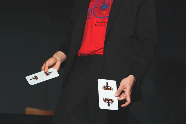 Neven performing with oversized playing cards